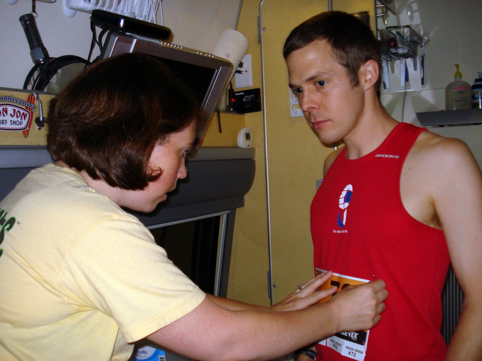 Erin pinning bib onto Matt